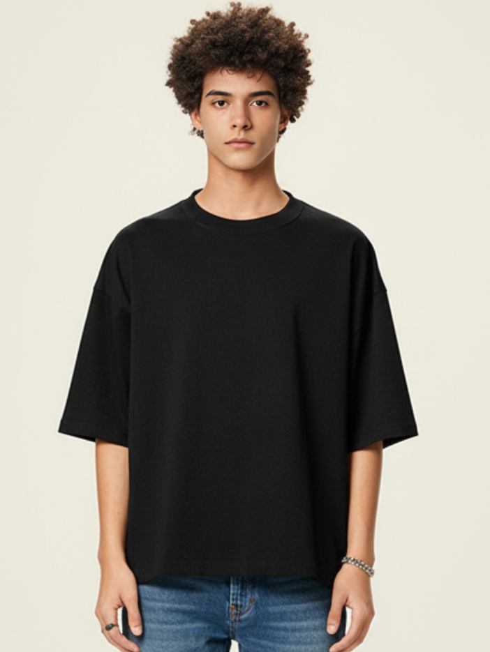 Person wearing a black t-shirt against a plain background